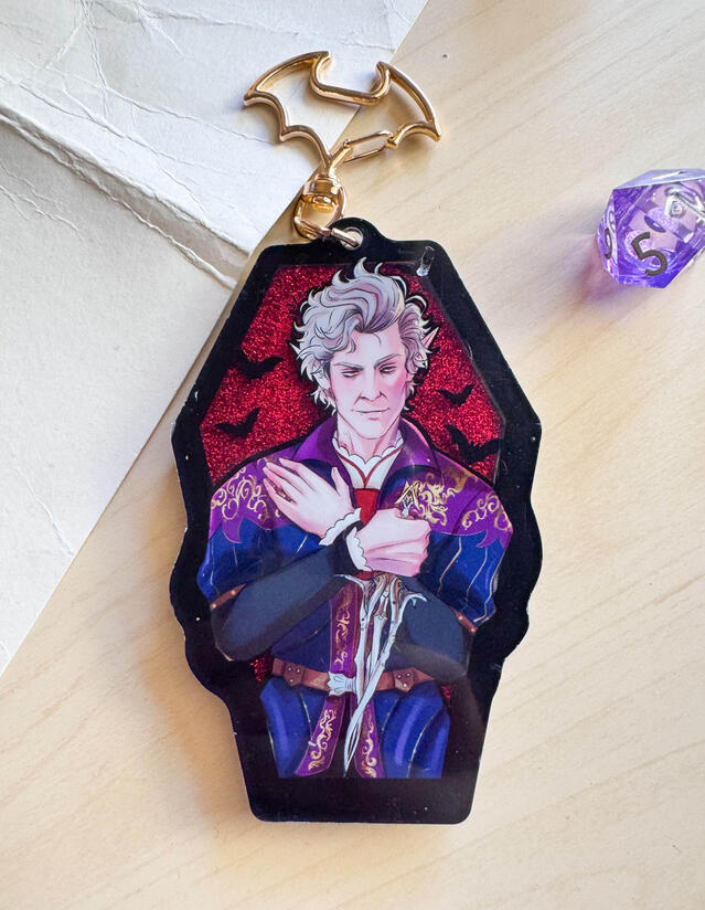 Coffin Liquid Charm - Features liquid glitter and gold embossing on the back.