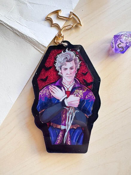 Coffin Liquid Charm - Features liquid glitter and gold embossing on the back. 2025.